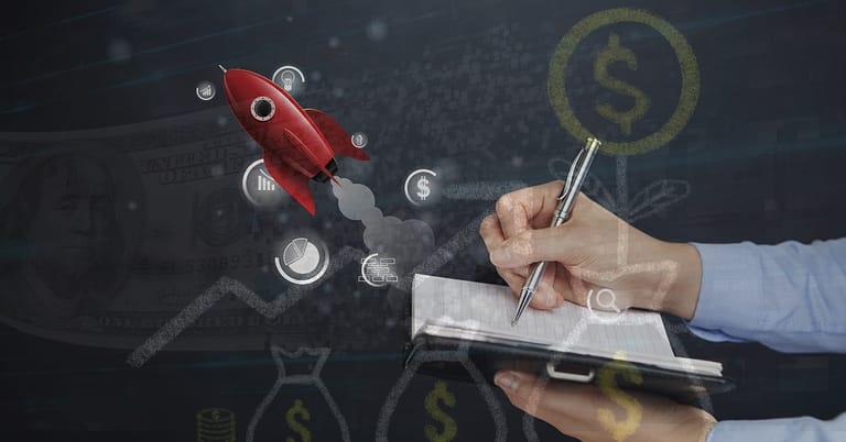 A person writes in a notebook with financial icons and a red rocket overlaid, symbolizing strategic financial planning or bootstrapping for startup funding.