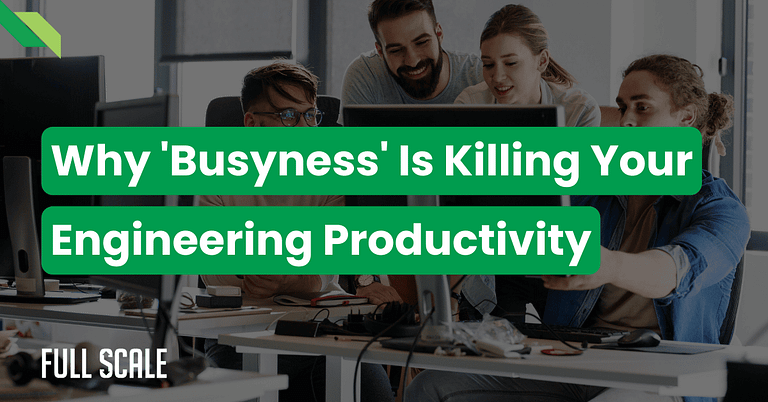 Four people in an office gather around two computer screens. Text overlay reads, "Why 'Busyness' Is Killing Your Engineering Productivity: Unveil the secrets to engineering output optimization.