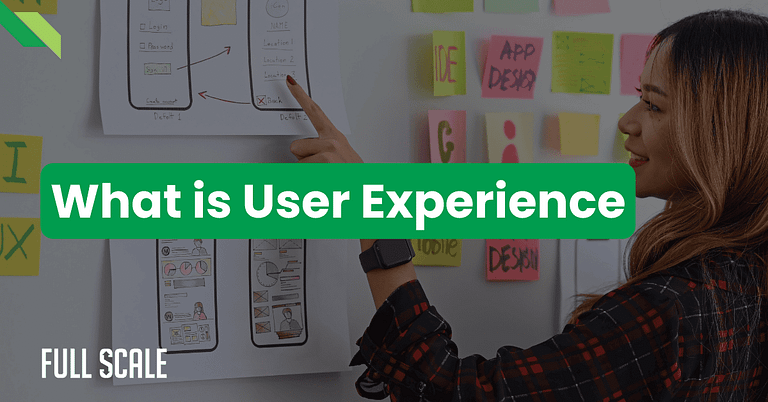 A woman points at user interface sketches on a wall covered with notes, illustrating key concepts in user experience design, with the text "What is User Experience" displayed prominently.