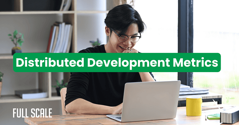 A person smiles while working on a laptop at a desk, with the text "Distributed Development Performance Metrics" overlaid, highlighting insights into distributed team productivity data.