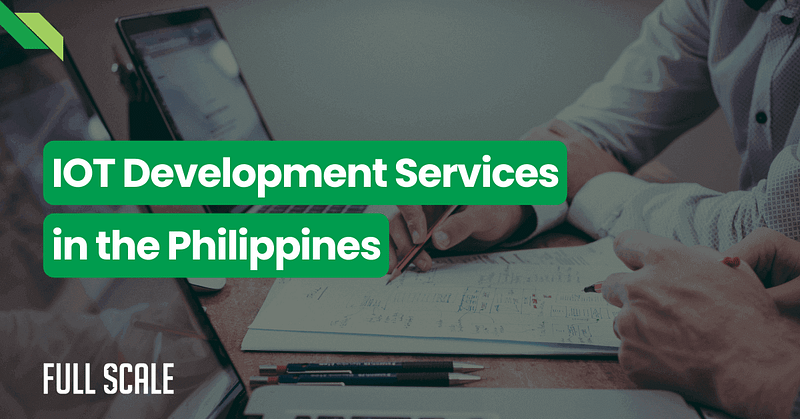 A close-up of two people working on a laptop and tablet with a blueprint. Overlaid text reads "IOT Development Services in the Philippines" and "FULL SCALE" is displayed in the corner.