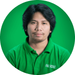 A man with medium-length black hair wearing a green polo shirt is shown against a solid green background.