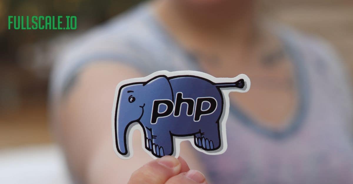 A person is holding up a sticker with the word "php" related to php web development on it.