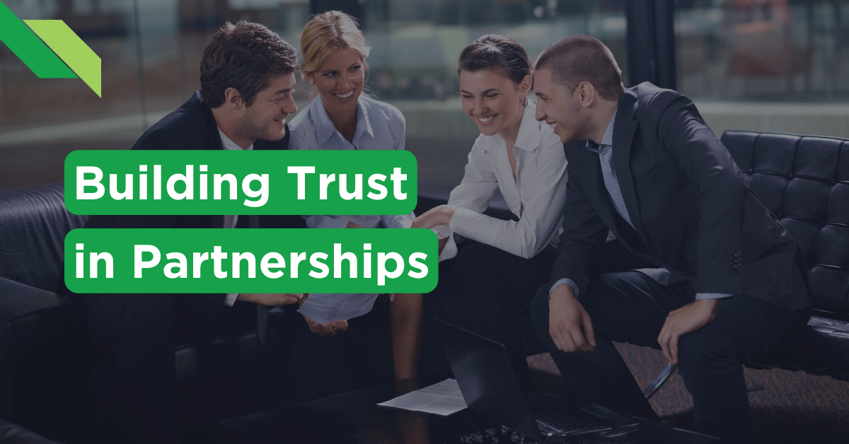 Four professionals engaging in a friendly discussion on a couch with the theme "building trust in partnerships"