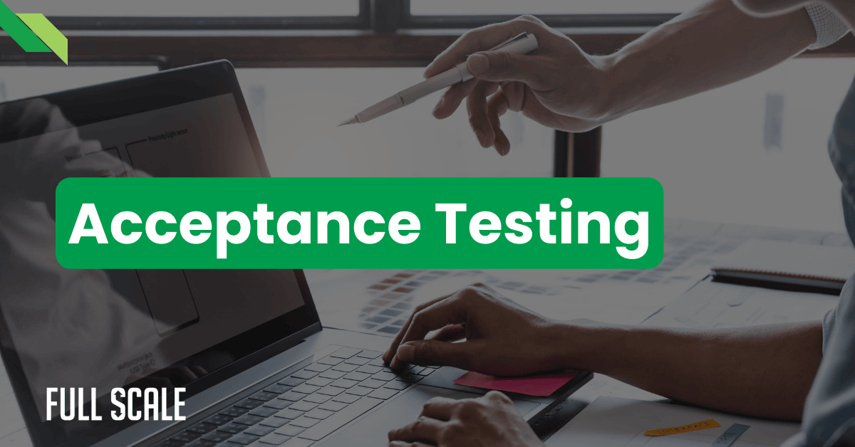 Two people work on a laptop; one points at the screen with a pen. The text "User Acceptance Testing Definition" is overlaid in a green box, providing clarity and focus on what user acceptance testing entails.