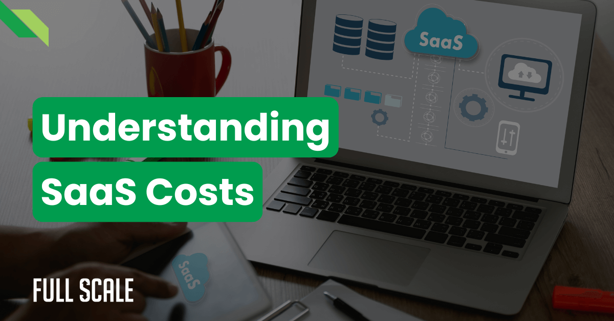 A laptop displaying SaaS costs information is on a desk with a red mug and various office supplies. Text overlay reads "Understanding SaaS Costs.